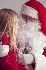 Obraz premium Girl on santa claus knees