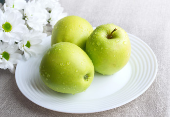 Three washed green apples 