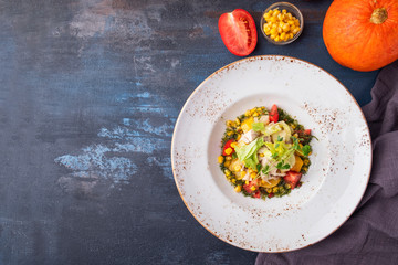 Healthy salad  with chicken fillet, corn,  tomatoes and baked pumpkin. Top view. Copyspace