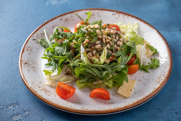 Closeup photo of arugula salad. Healthy food concept.