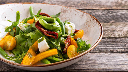 Pumpkin salad on a plate with space for text.