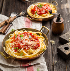 italian pasta with tomato sauce, grated cheese, basil leaves