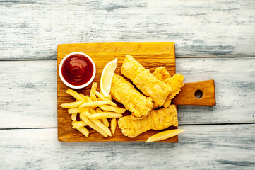 fish and chips with french fries, on wooden background 