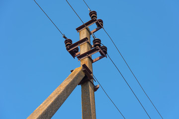 Power lines with various poles and supports, the appearance of an electrical transformer booth.