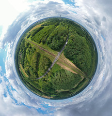 Aerial drone 360 degree panoramic view on railroad crossing with asphalt road in the forest, white truck with cargo on way