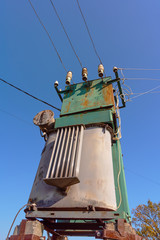 Power lines with various poles and supports, the appearance of an electrical transformer booth.