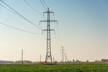 Power lines with various poles and supports, the appearance of an electrical transformer booth.
