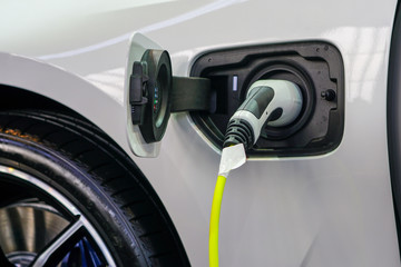The electric car charger plugged in to the socket