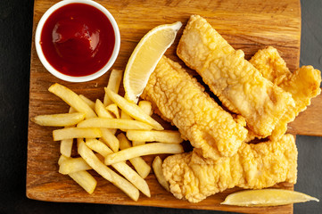 fish and chips with french fries, on a stone background