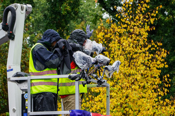 photo and video cameraman working at a event in the rain