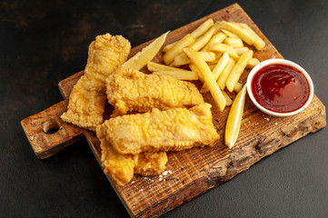 fish and chips with french fries, on a stone background