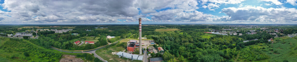 Aerial drone wide panoramic view on high concrete chimney in heating plant close to the city