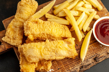 fish and chips with french fries, on a stone background