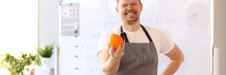 Man Blogger Holding Orange Cooking Vegetables