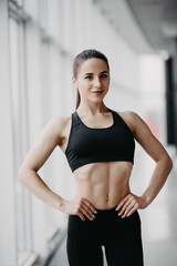 Fototapeta na wymiar Attractive fitness woman trained female body at gym