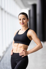 Fototapeta na wymiar Attractive fitness woman trained female body at gym