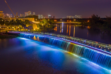 Fototapeta na wymiar Aerial view of Starlight Bridge or Anh Sao Bridge which is a pedestrian bridge with colored lights and waterfall in District 7 of Ho Chi Minh City also known as Saigon, Vietnam. 
