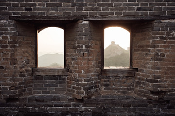 Fototapeta na wymiar Views from inside a watchtower on the Jinshanling section of the Great Wall of China during sunset in Hebei Province, near Beijing.