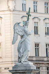 Beautiful winged angel of Baroque Era with a cross at Saint Karl Cathedral in Vienna, Austria