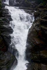 Close up of waterfall in Shillong in motion blurr  and rocks, selective focusing