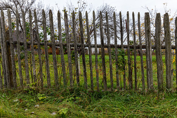 Fototapeta premium wooden fence with green grass and blue sky