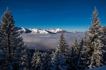 Inversion in valley and illuminated mountain peaks
