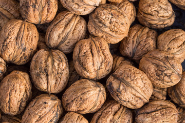 Walnuts. Whole walnuts background. Many walnuts close-up. Walnut texture.