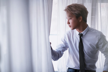 Young Asian businessman in white shirt and tie