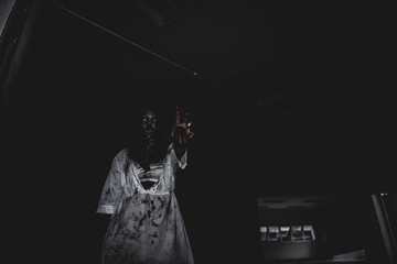 Portrait of asian woman make up ghost face with blood,Horror scene,Scary background,Halloween...