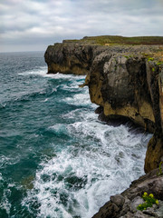 Cliff on the coasts of Asturias, in northern Spain, with the revolted sea.