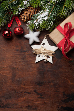 Christmas greeting card with gift box, decor and fir tree
