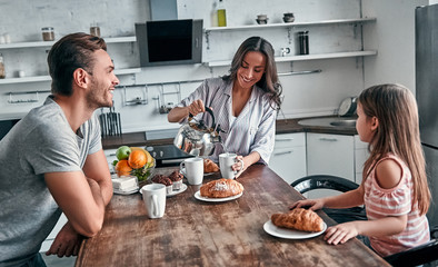 Family in kitchen - Powered by Adobe