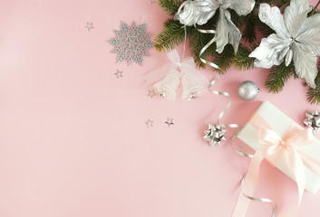 Christmas background . Xmas or new year silver color decorations on pastel pink background with empty copy space for text.  holiday and celebration concept for postcard or invitation. top view 
