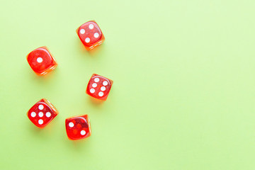 Red dice lying on a green background. Place for text