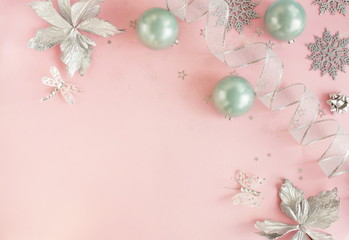 Christmas background. Xmas or new year white silver color decorations on pastel pink background with empty copy space for text.  holiday and celebration concept for postcard or invitation. top view 