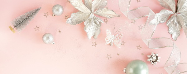 Christmas background banner. Xmas or new year white silver color decorations on pastel pink background with empty copy space for text.  holiday and celebration concept. top view 