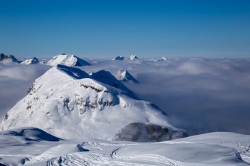 Panorama of mountains rising from the clouds