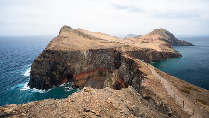 Fototapeta na wymiar A hiking trail consisting of rock and gravel paths leads over the Ponta de São Lourenço