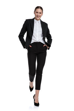 businesswoman walking relaxed with hands in pockets