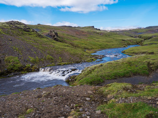 Fototapeta na wymiar Beautiful lush green Landscape of Skoga river valley cascades near Skogafoss waterfall and Skogar end of Fimmvorduhals hiking trail. South Iceland, Summer blue sky