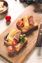 Tasty sandwiches on wooden board