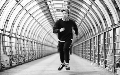 A man in sportswear run outdoors monochrome photo