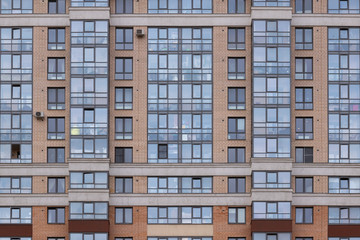 Fototapeta na wymiar Modern architecture brick and glass facade high rise residential building front view.