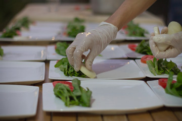 chef preparing salad in table