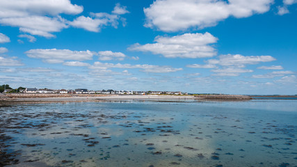 View from Salthill beach of calm waters of Galway bay on a summer day.