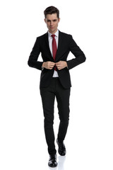 Charming businessman unbuttoning his jacket