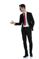 Cheerful businessman holding his hand in his pocket and explaining