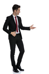 Interested young businessman indicating something on the side