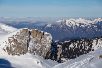 Panorama of winter Alps with low clouds