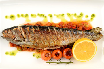 Fish with lemon and parsley on a plate